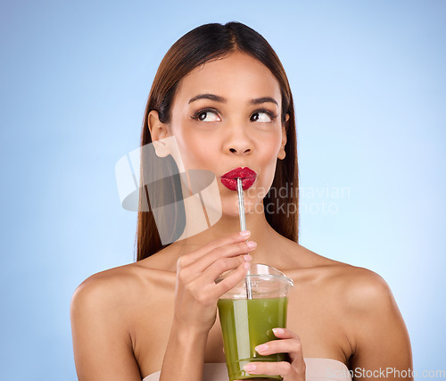 Image of Beauty, smoothie and health with woman in studio for detox, nutrition and diet. Organic, drinking and minerals with girl model and green juice on blue background for vegan, fiber and protein