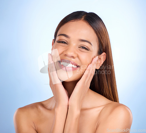 Image of Skincare, beauty and portrait of happy woman in studio for glowing skin or natural makeup on blue background. Cosmetics, facial and dermatology, face of model with smile and mockup in studio promo.