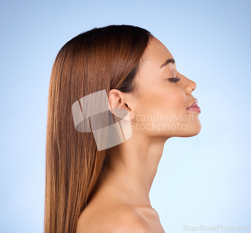 Image of Skincare, cosmetics and profile of woman in studio with skin promo on blue background. Makeup, facial and face of beauty model from Brazil for dermatology or haircare promotion and mockup.