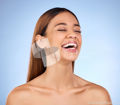 Image of Skincare, beauty and laughing black woman in studio with smile for skin glow promo on blue background. Makeup, facial and cosmetics, face of African model for dermatology or spa promotion and mockup.