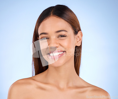 Image of Skincare, beauty and smile, portrait of woman in studio for glowing skin or natural spa makeup on blue background. Cosmetics, facial and dermatology, face of happy hispanic model in studio mockup.