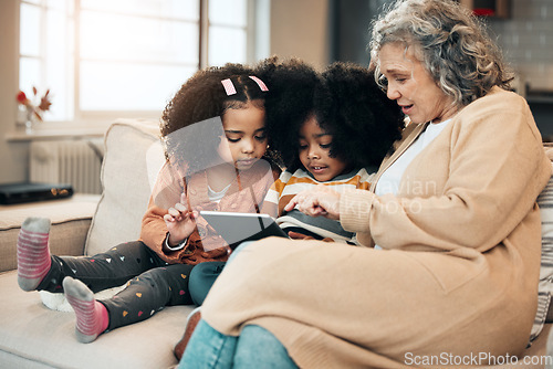 Image of Watching, entertainment and children with grandmother and a tablet for games, education or website. Interracial, digital and siblings playing on tech, streaming a show and film with a senior woman