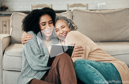 Image of Tablet, daughter hug and happy senior mother with digital photo album, bonding and enjoy quality time together at home. Living room floor, memory and biracial family, people or mom and girl embrace