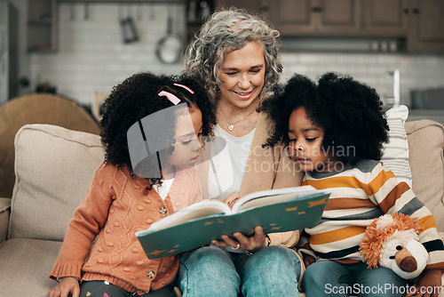 Image of Family children, book and grandma reading fantasy storybook, story or bond on home living room sofa. Love, grandma babysitting and elderly woman with child development for biracial kindergarten kids