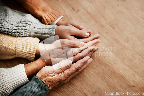 Image of People, hands together and generations in care above on mockup for unity, compassion or trust on wooden table. Group holding hand in collaboration, love or support for community, teamwork or union