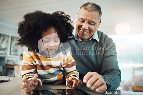 Image of Education, home school and grandfather helping child with reading for an assignment or project. Learning, bonding and elderly man teaching boy kid grandchild with homework in the living room at home.