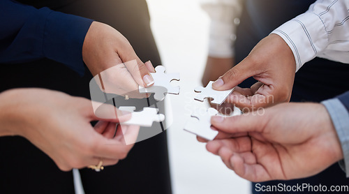 Image of Team, hands and puzzle for teamwork, solution and integration, synergy and collaboration. Hand, business people and jigsaw for strategy, support and partnership, innovation and unity in cooperation