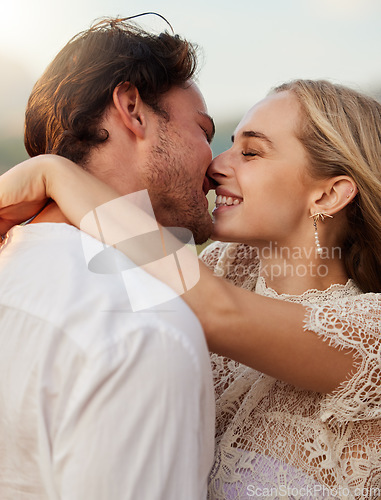 Image of Couple, kiss and hug outdoor with a smile, love and romance on date in nature. Young man and woman happy together on valentines day with trust, peace and freedom or support in forest for anniversary
