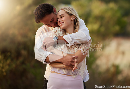 Image of Couple, love and hug outdoor for care, trust and romance with safety and security. Happy man and woman together on valentines day date with flare, peace and freedom in nature forest holding hands
