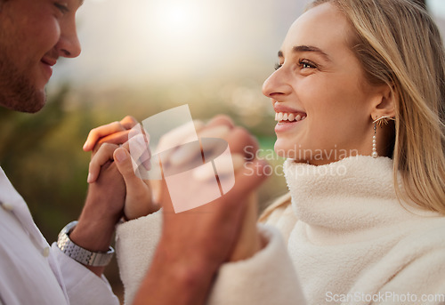 Image of Holding hands, couple and love outdoor with a smile, care and romance on date in nature. Young man and woman happy together on valentines day with trust, peace and support in forest for anniversary