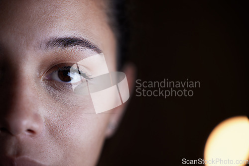 Image of Looking, dark and portrait of a woman in the office for a deadline, overtime and working late. Mockup, serious and half face of an employee in the workplace at night for work and corporate dedication