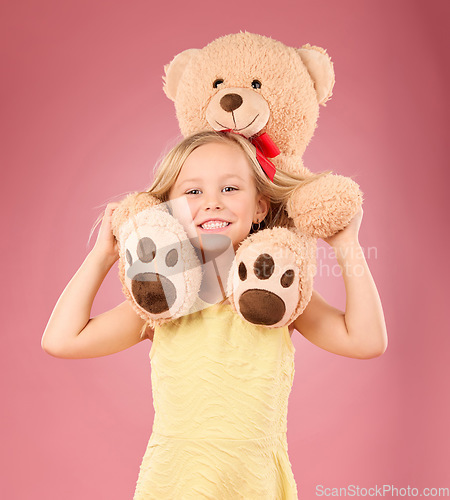 Image of Teddy bear, girl smile and portrait with a soft toy with happiness and love for toys in a studio. Isolated, pink background and a young female child feeling happy, joy and cheerful with plaything