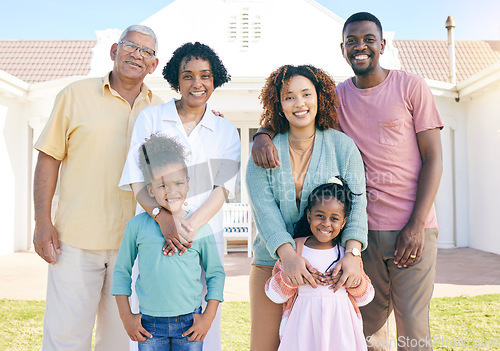 Image of Happy portrait of an interracial family outside house with a smile, happiness and care on the lawn. Visit, together and parents, grandparents and children with love, smiling and bonding in garden