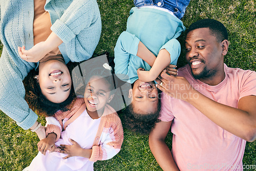 Image of Top view, black family and parents with kids on grass, carefree and happiness on vacation, relax and smile. Mother, father and children in park, freedom and playful together, love and bonding outdoor