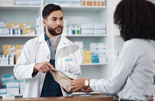 Image of Medicine, prescription and explaining with a pharmacist man talking to a woman customer for healthcare. Medication, consulting and insurance with a male health professional working in a pharmacy