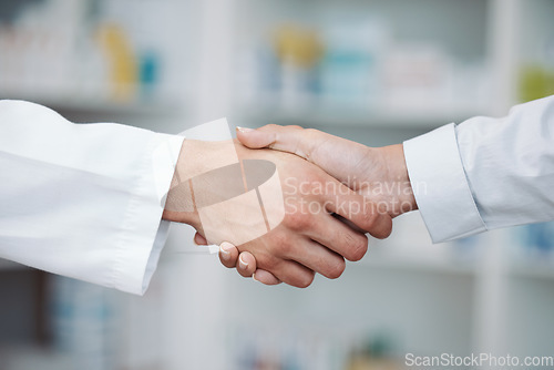 Image of Doctor, handshake and partnership in support at pharmacy for healthcare success, promotion or deal at clinic. Medical expert shaking hands in teamwork for life insurance, b2b or pharmaceutical needs