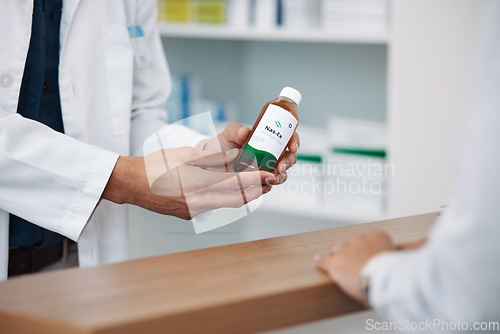 Image of Doctor, hands and prescription medicine over the counter for consultation, healthcare or pharmaceutical product at clinic. Hand of pharmacist showing medical solution for healthy cure at pharmacy