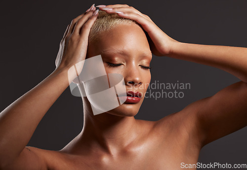 Image of Skincare, makeup and black woman with hands on head in dark studio, platinum hair isolated on grey background. Art aesthetic, cosmetics and African beauty model and luxury spa facial for bronze skin.