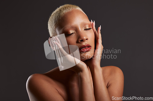 Image of Beauty, makeup and skincare, black woman with cosmetics in dark studio with platinum hair style isolated on grey background. Art, aesthetic and relax, African model in skin glow and luxury spa facial
