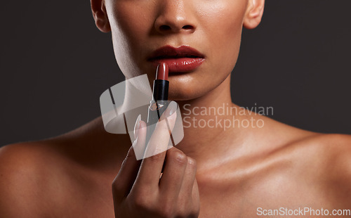 Image of Makeup, lips and hands of woman with lipstick in studio for cosmetics and skincare products. Salon aesthetic, cosmetology and girl model with red gloss for beauty, mouth and luxury style