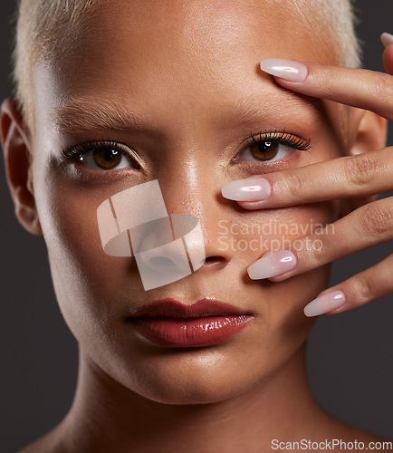 Image of Makeup, hands on face and portrait of woman in studio for beauty products, cosmetics and skincare. Salon aesthetic, cosmetology and zoom of girl with manicure, self love and luxury on gray background