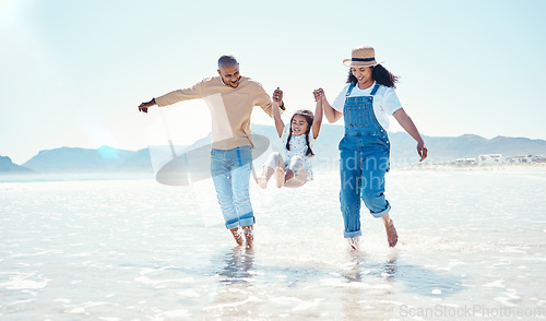 Image of Playing, parents and girl in water at beach for bonding, quality time and summer adventure together. Travel, family and happy mom and dad swinging child enjoy holiday, vacation and relax on weekend