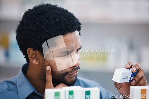 Image of Black man, medical product and thinking in pharmacy for reading, choice and pills in retail healthcare. African customer, box and sale for health, deal and wellness for benefits of medicine in store