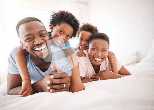 Image of Happy, laughing and portrait of a black family on a bed for playing, quality time and comfort. Bonding, love and African children with parents in bedroom for happiness and relaxation in the morning