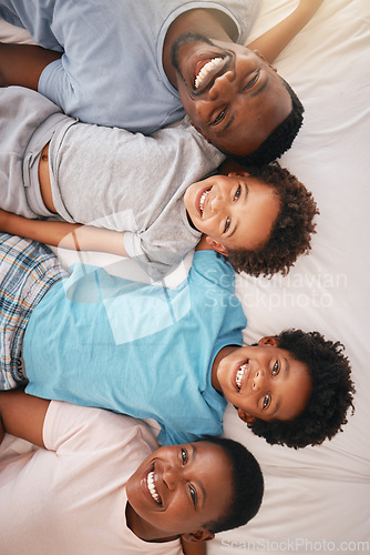 Image of Happy black family, bed portrait and top view with happiness, kids and together with dad, mom and love. African children smile, parents and bedroom for bonding, care or support in morning for holiday