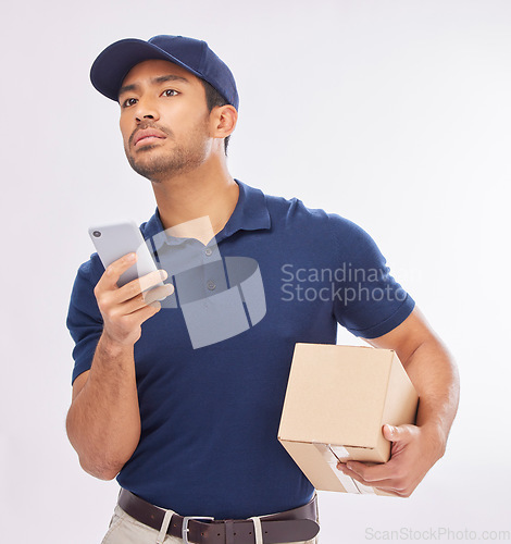 Image of Delivery, ecommerce and courier with a phone using map to navigate with mobile app on the internet, web or website. Box, package and man worker holding shipment isolated in a studio white background