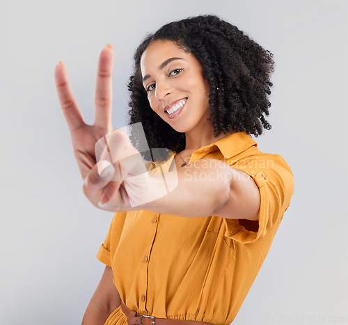 Image of Happy, peace sign and portrait of woman in studio for positive, agreement and support. Thank you, yes and emoji with female isolated on gray background for achievement, confident and thank you