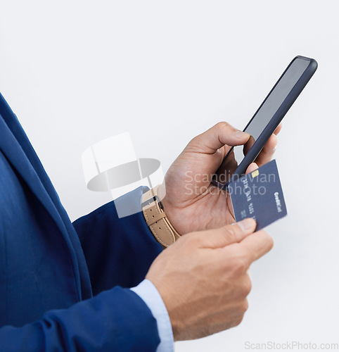 Image of Credit card, phone and hands of man in studio for online shopping, fintech and investment. Banking, ecommerce and app with male isolated on gray background for customer experience, payment and retail