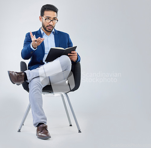 Image of Human resources, questions and businessman with notebook for interview process in studio on grey background. Recruiter, asian male and recruitment process, negotiation and onboarding discussion