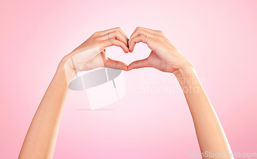 Image of Love, heart and hands of woman in studio for romance, positive and kindness. Peace, support and emoji with female and shape isolated on pink background for emotion, hope and happiness gesture