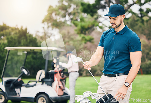 Image of Golf, sports and man on course with golfing bag of clubs ready to start game, practice and training on lawn. Professional golfer, activity and male caddy on grass for exercise, fitness and recreation