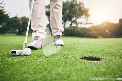 Image of Golf, closeup and golfer or player hit ball and professional athlete training and putting on a filed as exercise or workout. Feet, equipment and gentleman or person relax and playing a sport