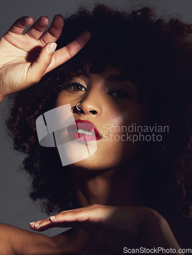Image of Red lipstick, shadow and makeup on black woman with beauty, afro or natural hair in studio. Face of aesthetic female model with a skin glow, shine and color on lips for art, power and facial skincare