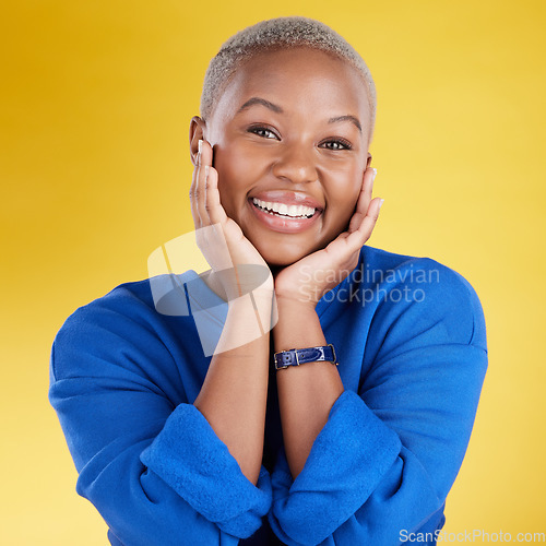 Image of Smile, hands on face and portrait of black woman in studio with happy, positive mindset and confident. Cosmetics, facial expression and African girl with natural glow excited on yellow background