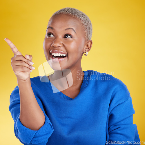 Image of Smile, pointing to mockup and black woman in studio isolated on a yellow background. Thinking, happy and African female model point to advertising, marketing or product placement for branding space.