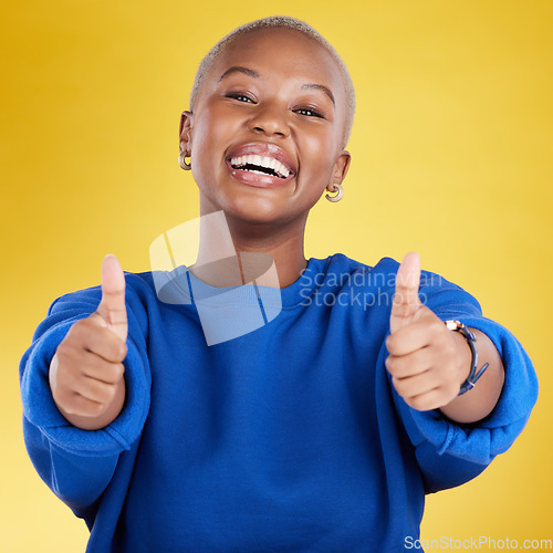 Image of Laughing, portrait and black woman with thumbs up in studio isolated on a yellow background. Happy, emoji face and funny female with hand gesture for agreement, support or approval, like or success.