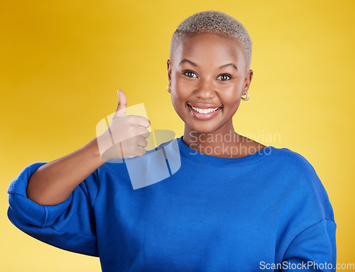 Image of Portrait, smile and black woman with thumbs up in studio isolated on a yellow background. Success, emoji face and happy African female with hand gesture for agreement, support or approval, like or ok