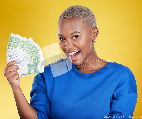 Image of Portrait, money winner and black woman with euros in studio isolated on a yellow background. Financial freedom, wealth and face of happy, excited and rich female with cash after winning lottery prize