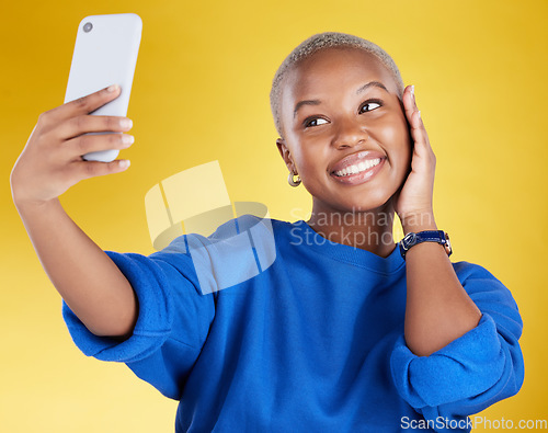 Image of Smile, selfie and beauty of black woman in studio isolated on a yellow background. Photographer, social media and African female model taking pictures or photo for profile picture and happy memory.