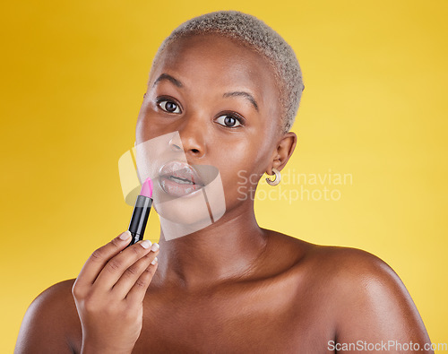 Image of Face portrait, makeup and black woman with lipstick in studio isolated on a yellow background. Cosmetics, beauty and African female model with lip gloss product for aesthetics, wellness and skincare.