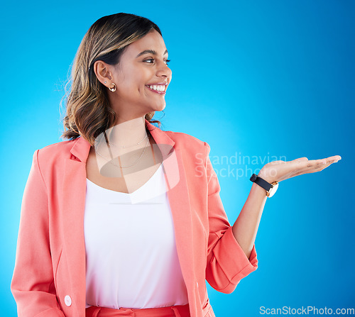 Image of Smile, mockup and business woman with product placement in studio isolated on a blue background. Mock up, promotion and happy Indian female with palm for advertising, marketing or branding space.