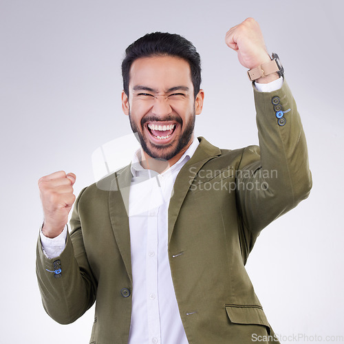 Image of Yes, winner and happy man portrait isolated on white background celebration for opportunity, bonus or winning. Asian business person, fist pump and celebrate competition or promotion news in studio