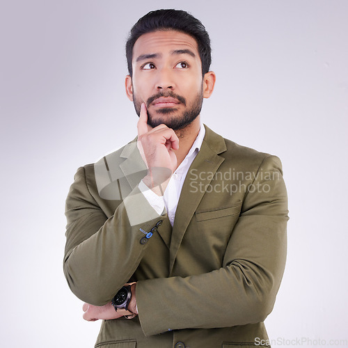 Image of Business man, thinking face and planning in studio with ideas or strategy on a gray background. Asian male entrepreneur think with hand on chin while pensive or contemplating question or thought