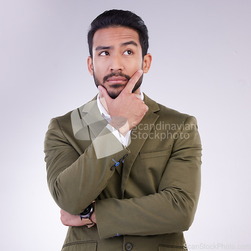 Image of Business man, hand on face and thinking in studio with ideas or strategy on a gray background. Serious asian male entrepreneur think while confused, doubt or contemplating question on mockup space