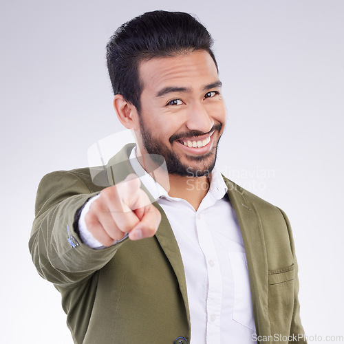 Image of Portrait, success and Asian man pointing to you, happiness and cheerful against a grey studio background. Face, Japanese male employee and guy with gesture for space or finger show choice or decision