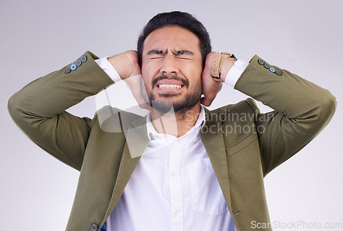 Image of Business, stress and Asian man cover ears, loud and mental health against a grey studio background. Male employee, anxious worker and entrepreneur with hands on temple, noisy and blocking for silence